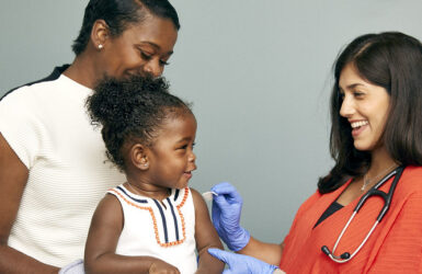 Toddler about to receive a vaccine from a doctor, image by SELF magazine