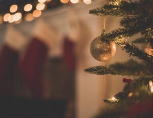 Christmas tree with cosy fire and stockings in the background