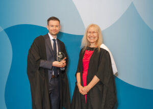 Dr John Connelly receiving his award with Dr Kristina Strutt.
