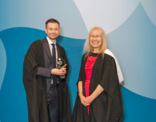 Dr John Connelly receiving his award with Dr Kristina Strutt.