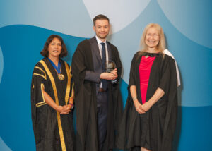 Dr John Connelly at the Annual Awards Ceremony with President, Dr Sheuli Porkess, and Chair of the Board of Examiners, Dr Kristina Strutt.
