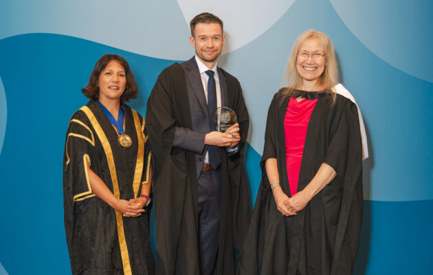 Dr John Connelly, winner of the Academic Achievement Award 2026, at the Annual Awards Ceremony with President, Dr Sheuli Porkess, and Chair of the Board of Examiners, Dr Kristina Strutt.